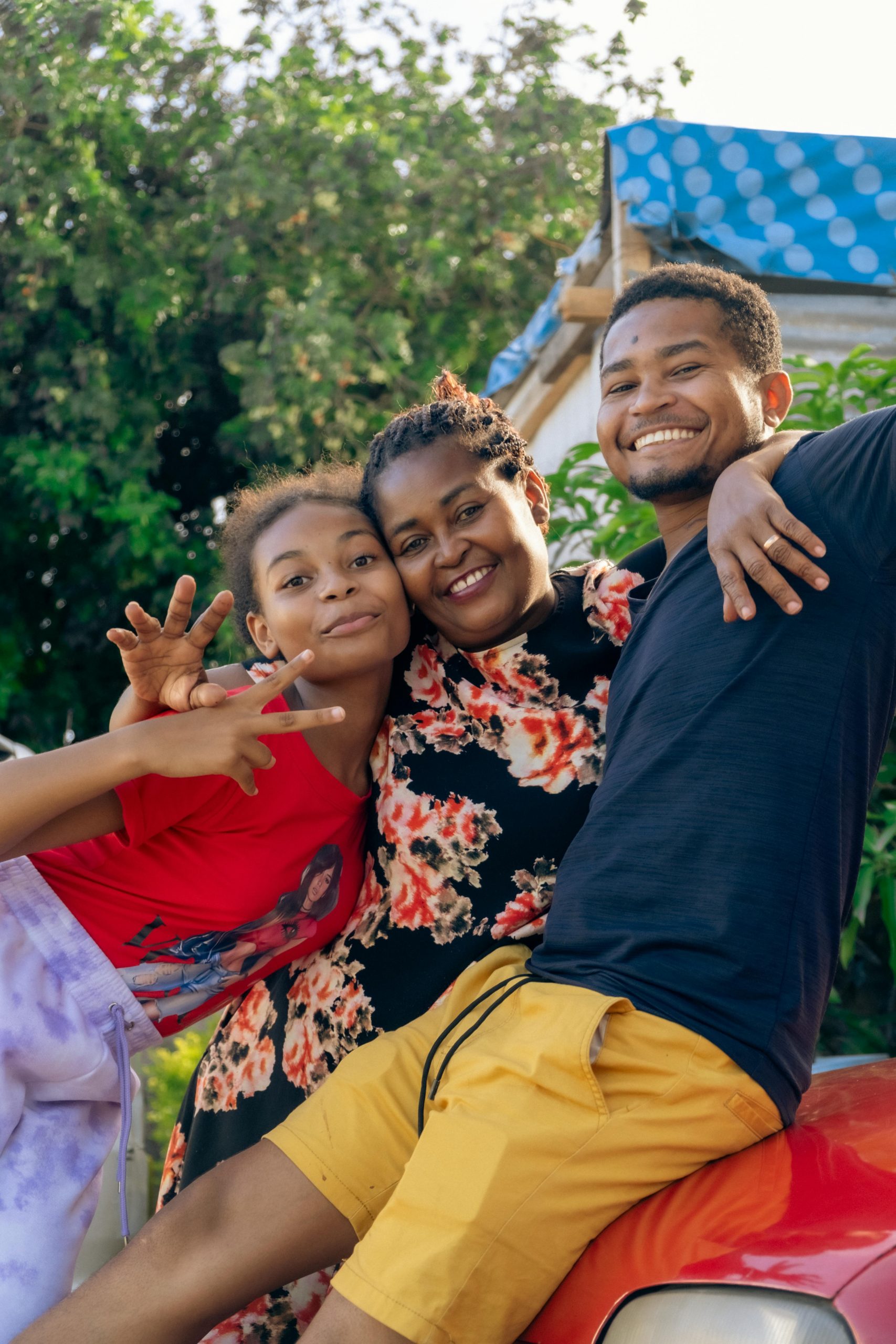 Happy family posing together outdoors, exuding joy and unity on a sunny day.